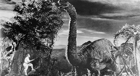 Still image of a man and a dinosaur from the film The Lost World.