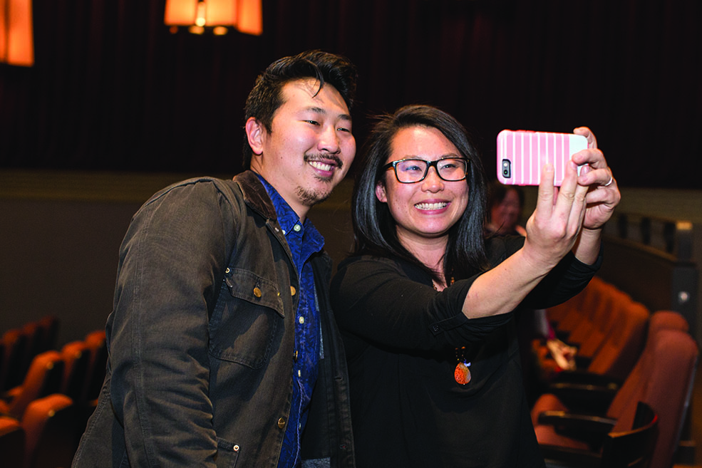 Andrew Ahn takes a photo with a guest at IU Cinema