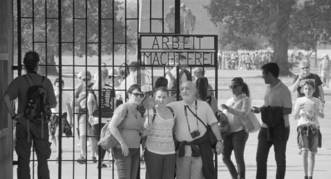 Image of a group of people standing in front of a gate from the film Austerlitz.