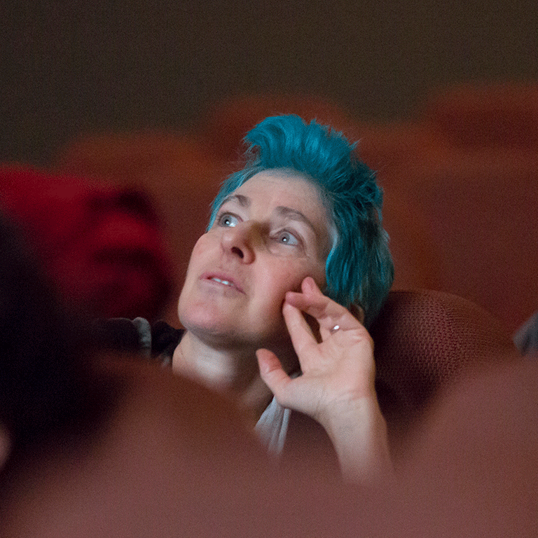 Beth B sits in the seats at IU Cinema.