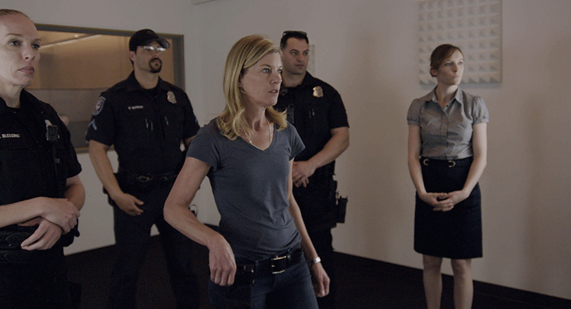 a group of law enforcement offices stand in a room from the film bias