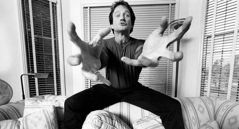 Robin Williams reaches towards the camera from the film Robin Williams: Come Inside My Mind.