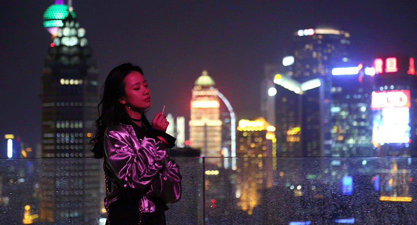 a women stands with a city in the background from the film Dead Pigs