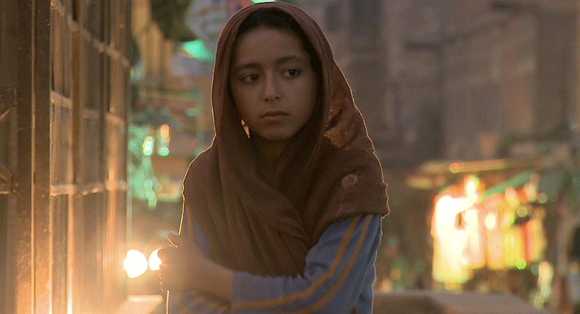 a girl stands in the street from the film The Dream of Shahrazad