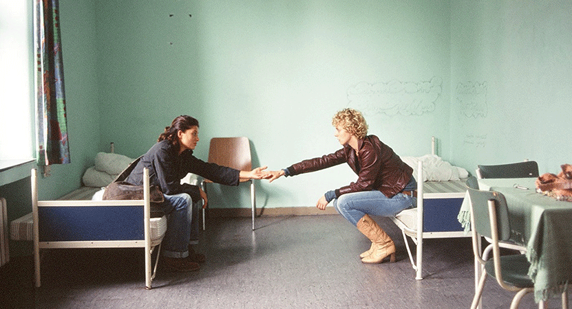 two women sit facing each other holding hands film the film Auf der Anderen Seite (The Edge of Heaven)