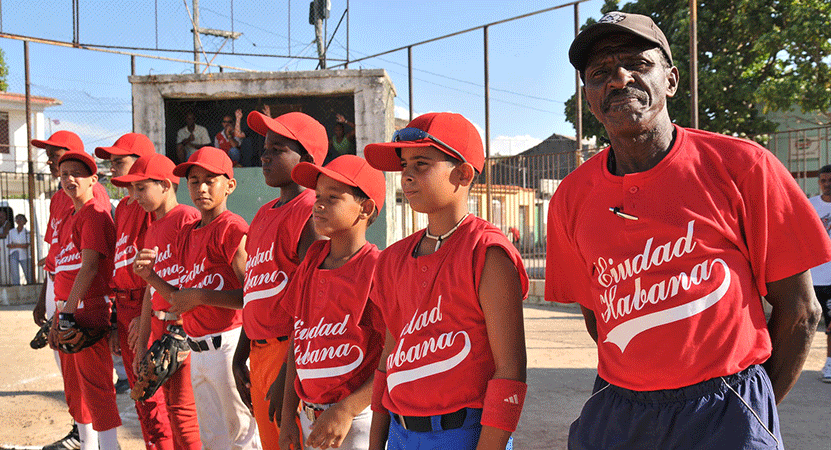 A youth baseball team lined up on the field from the film Ghost Town to Havana.