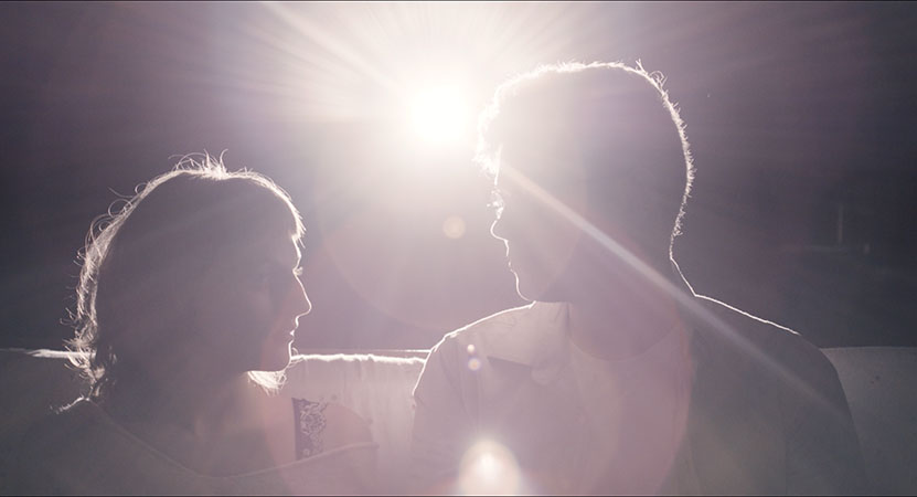 a man and a women backed by light from a student film in the program Montage: A Celebration of Moving Pictures: Spring 2020 Student Films Showcase