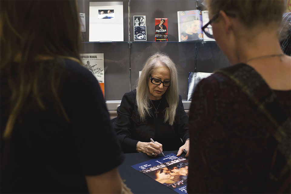 Penelope Spheeris signing posters after an event at IU Cinema.