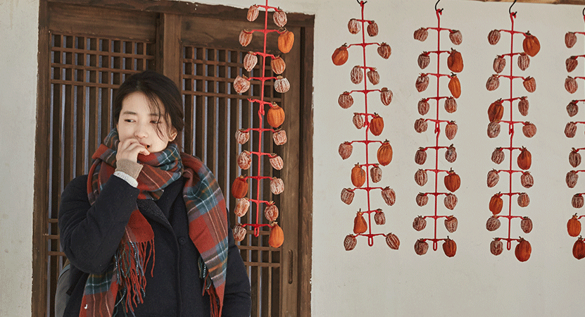 a young women stands outside from the film 리틀 포레스트 (Little Forest)