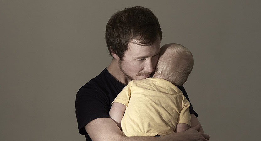 a man embraces his child from the film Seahorse