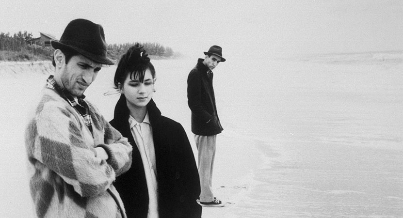 a group of people stand on a beach form the film Stranger Than Paradise