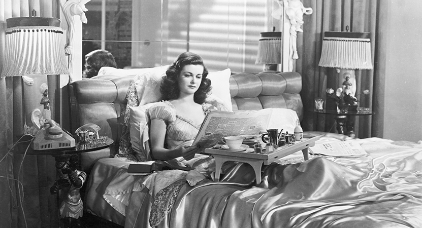 A women sits in bed from the film The Woman in the Window