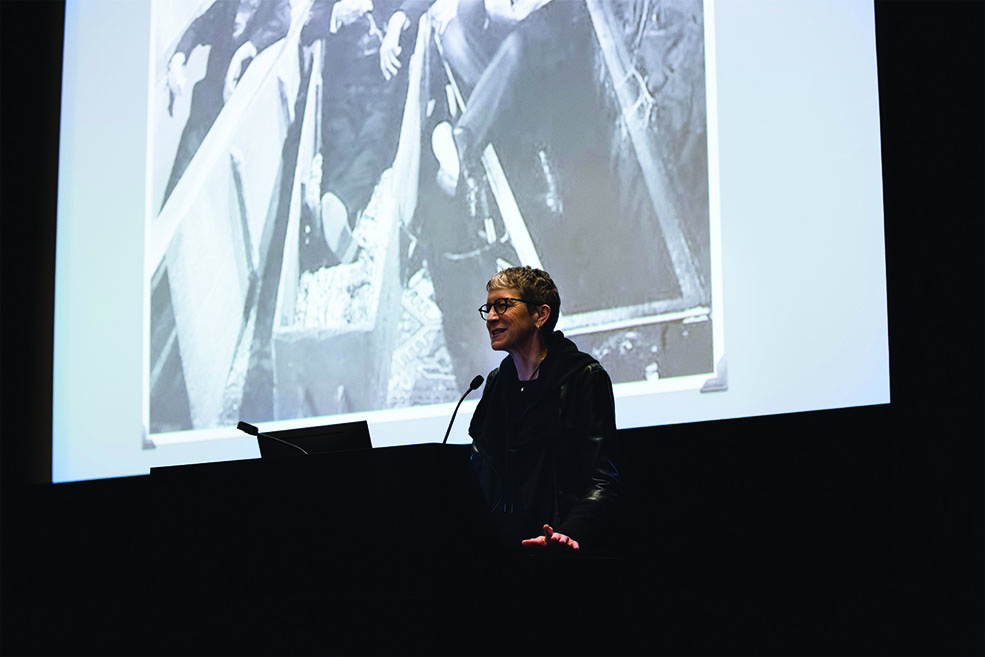 Victoria Price presenting a lecture onstage at IU Cinema.