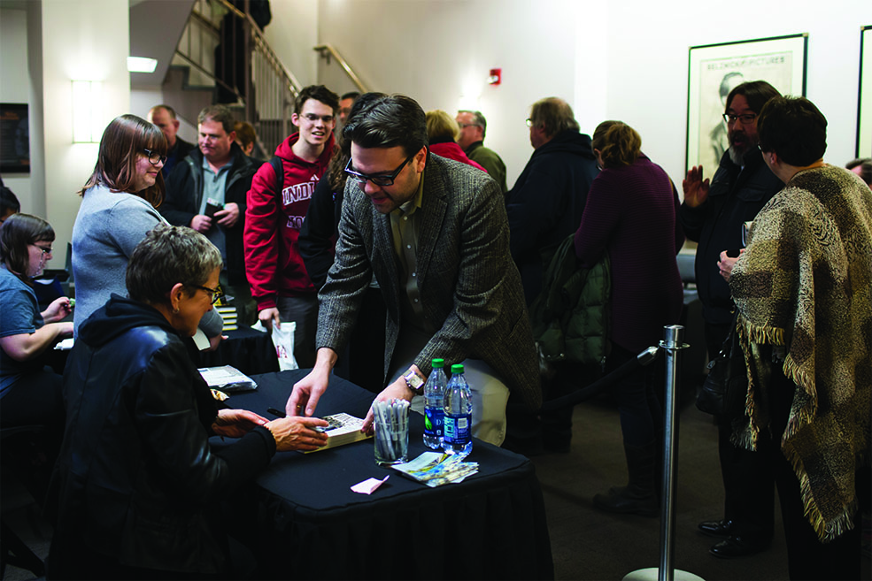 Victoria Price greeting guests and signing books at IU Cinema.
